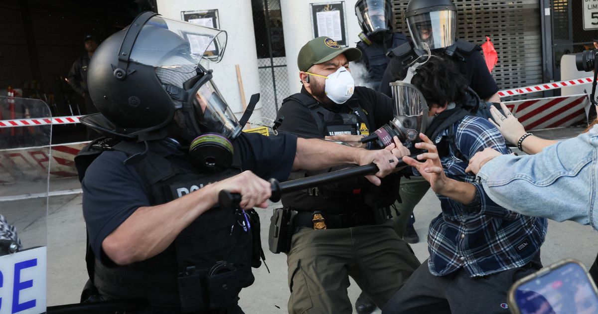 Protesters clash with masked police during a "National Shutdown" protest against U.S. Immigration and Customs Enforcement Jan. 30 in Los Angeles.