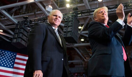 Radio talk show host Rush Limbaugh, left, appears on stage alongside President Donald Trump at a Make America Great Again rally in Cape Girardeau, Missouri, in a file photo dated Nov. 5, 2018.