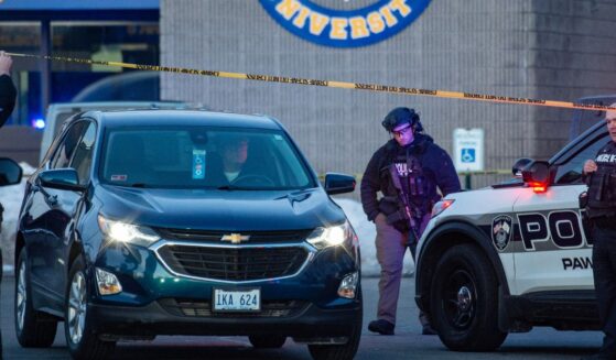 Police stand outside the perimeter they created around the Dennis M. Lynch Arena where a shooting occurred earlier Monday in Pawtucket, Rhode Island.