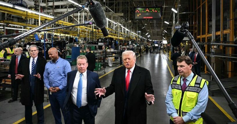 President Donald Trump speaks alongside Ford executive chairman Bill Ford, third from left, Ford CEO Jim Farley, right, Treasury Secretary Scott Bessent, left, and plant manager Corey Williams as he tours Ford Motor Company's River Rouge complex in Dearborn, Michigan, on Jan. 13.