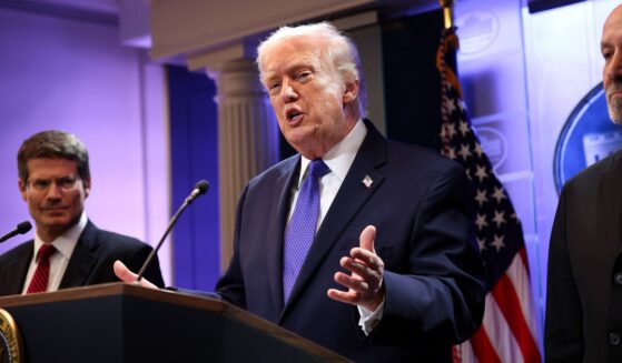 President Donald Trump, flanked by Solicitor General John Sauer, left, and Secretary of Commerce Howard Lutnick, right, speaks during a news briefing Friday at the White House in Washington, D.C.