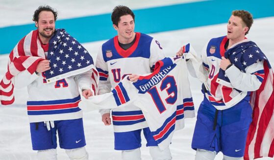 Auston Matthews #34, Zach Werenski #8 and Matthew Tkachuk #19 of Team United States celebrate their team's gold medal victory Sunday in the men`s ice hockey final match between USA and Canada at the 2026 Winter Olympic games in Milan, Italy.