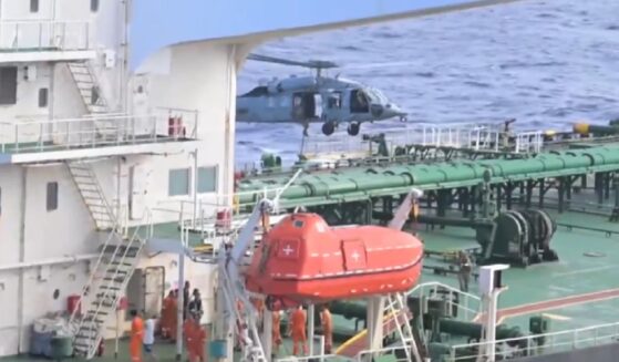 A U.S. military copter lands a boarding party aboard the rogue tanker Aquila II on Monday in the Indian Ocean.