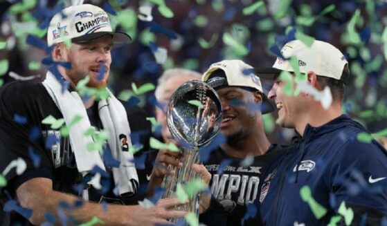 Seattle Seahawks quarterback Sam Darnold, left, and head coach Mike Macdonald hold the Lombardi Trophy after a win over the New England Patriots in the NFL Super Bowl LX on Sunday in Santa Clara, California.