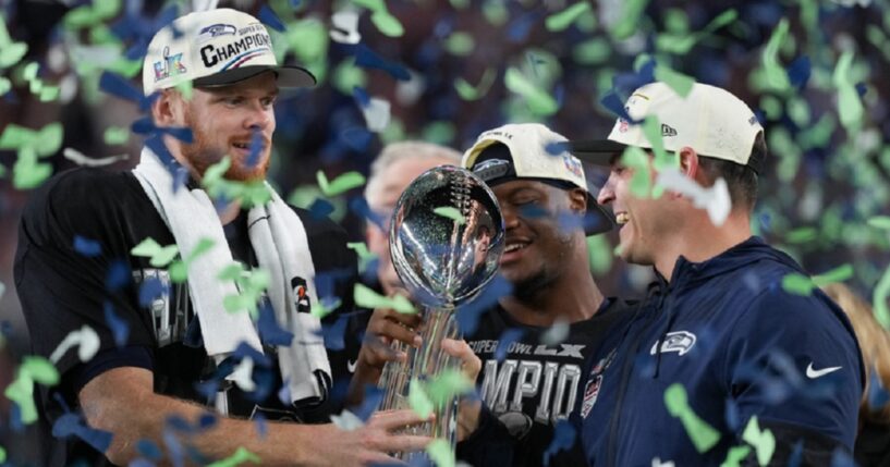 Seattle Seahawks quarterback Sam Darnold, left, and head coach Mike Macdonald hold the Lombardi Trophy after a win over the New England Patriots in the NFL Super Bowl LX on Sunday in Santa Clara, California.