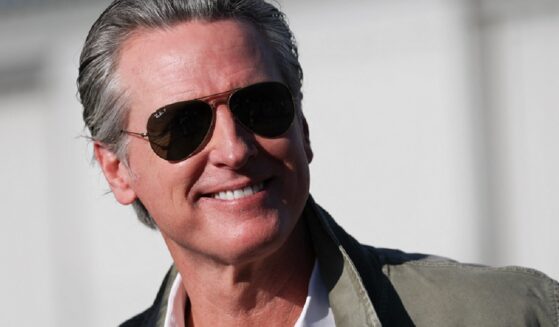 California Governor Gavin Newsom grins for the camera at a Feb. 2 news conference Montgomery-Gibbs Executive Airport in San Diego, California.