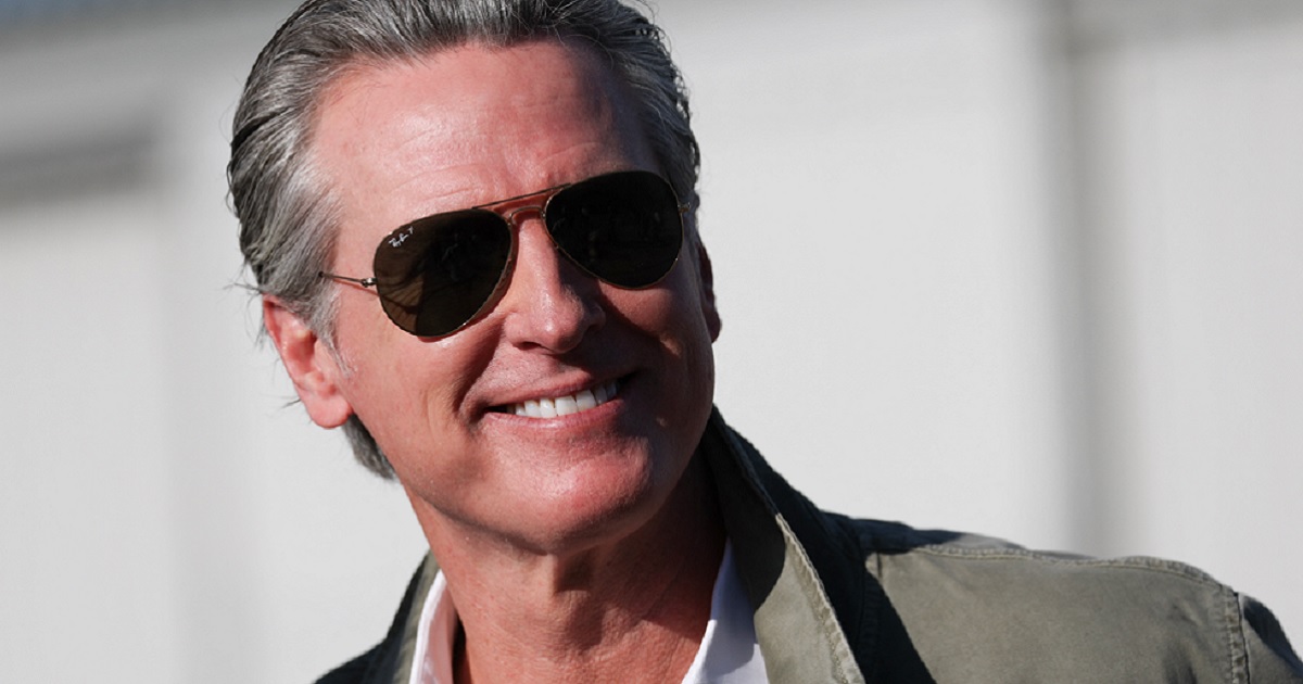 California Governor Gavin Newsom grins for the camera at a Feb. 2 news conference Montgomery-Gibbs Executive Airport in San Diego, California.