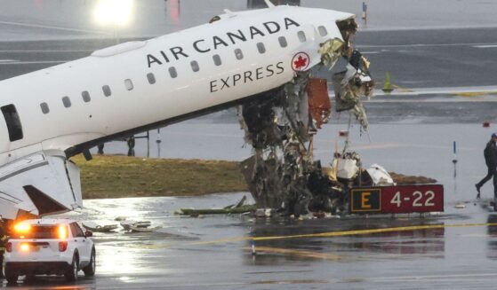 An Air Canada Express CRJ-900 sits on the runway Monday after colliding with a Port Authority fire truck Sunday night at LaGuardia Airport in New York.