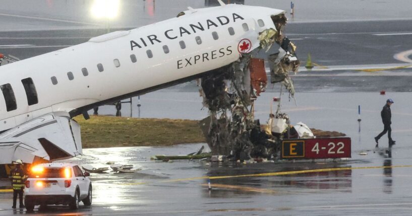 An Air Canada Express CRJ-900 sits on the runway Monday after colliding with a Port Authority fire truck Sunday night at LaGuardia Airport in New York.