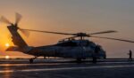 In this handout released by the U.S. Navy, an MH-60S Sea Hawk helicopter, attached to Helicopter Sea Combat Squadron (HSC) 14, lands on the flight deck of the Nimitz-class aircraft carrier USS Abraham Lincoln (CVN 72) in support of Operation Epic Fury on March 2, 2026.