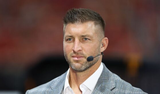 Tim Tebow sits on the set of SEC Network prior to the 2025 Aflac Kickoff Game between the Syracuse Orange and the Tennessee Volunteers at Mercedes-Benz Stadium on Aug. 30, 2025, in Atlanta, Georgia.