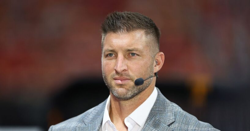 Tim Tebow sits on the set of SEC Network prior to the 2025 Aflac Kickoff Game between the Syracuse Orange and the Tennessee Volunteers at Mercedes-Benz Stadium on Aug. 30, 2025, in Atlanta, Georgia.