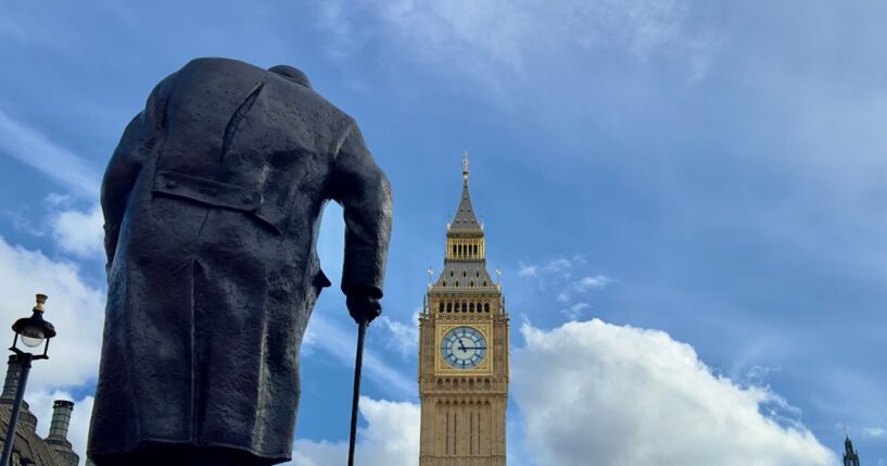 Big Ben and the Houses of Parliament with a statue of Sir Winston Churchill seen from behind in the foreground on March 4, 2024, in London, England.