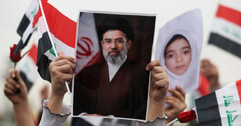 A schoolgirl holds up a poster of Iran's new supreme leader Mojtaba Khamenei during an anti-U.S. and Israel demonstration in Baghdad on March 12, 2026.
