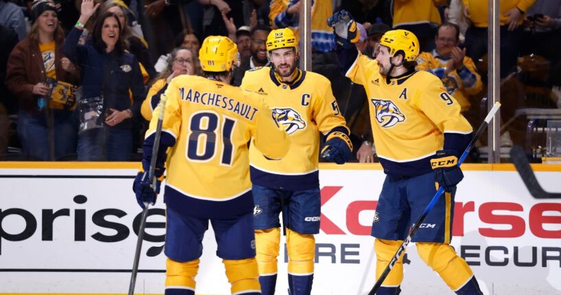 Filip Forsberg, Jonathan Marchessault, and Roman Josi of the Nashville Predators celebrate after a goal during the first period of the game against the San Jose Sharks at Bridgestone Arena on March 24, 2026, in Nashville, Tennessee.