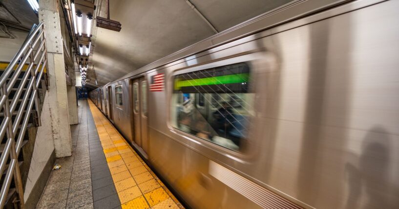 Subway train arriving at station in New York City underground transportation system.