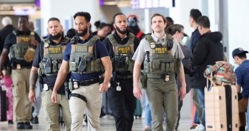 Federal law enforcement agents, including some with U.S. Immigration and Customs Enforcement, walk through LaGuardia Airport in New York on March 23, 2026.