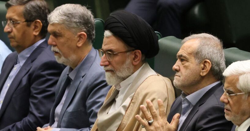 Iran's Minister of Intelligence Esmail Khatib, center, is pictured on Aug. 17, 2024, with Iran's President Masoud Pezeshkian (center right) before a speech to members of parliament in Tehran. Khatib was reportedly killed Tuesday night.