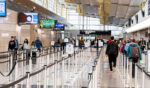 Travelers walk in the lines of Ronald Reagan International Airport on March 30, 2026.