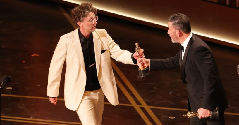 David Borenstein, left, accepts the Documentary Feature award from Jimmy Kimmel Sunday for