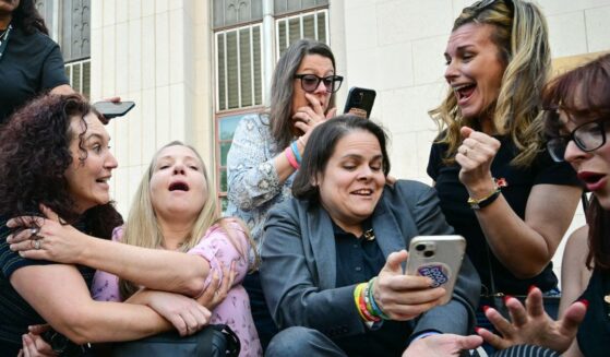 Laura Marquez-Garrett, center, in gray blazer, plaintiffs' attorney for the Social Media Victims Law Center, celebrates with family members of victims outside the Los Angeles Superior Court Wednesday as they react to news that a jury has found Meta and YouTube liable in a social media addiction trial. The jury found Meta and YouTube liable for harming a young woman through the addictive design of their social media platforms and ordered the companies to pay $3 million in damages.