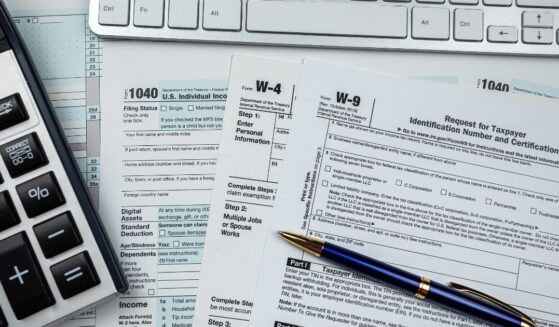 Blank tax forms sit on a desk.