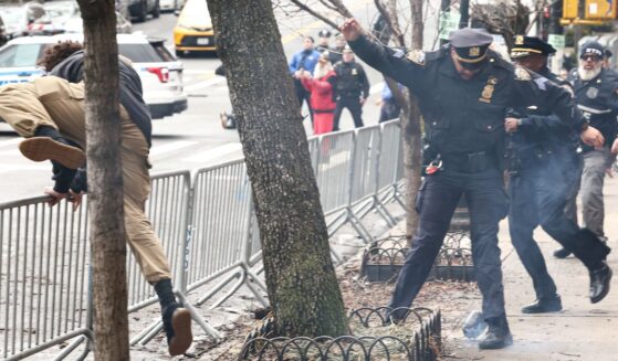 A left-wing activist flees the scene after throwing a homemade explosive device at anti-"Islamification" protesters in New York on March 7, 2026.