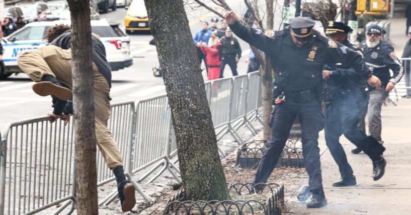 A left-wing activist flees the scene after throwing a homemade explosive device at anti-"Islamification" protesters in New York on March 7, 2026.
