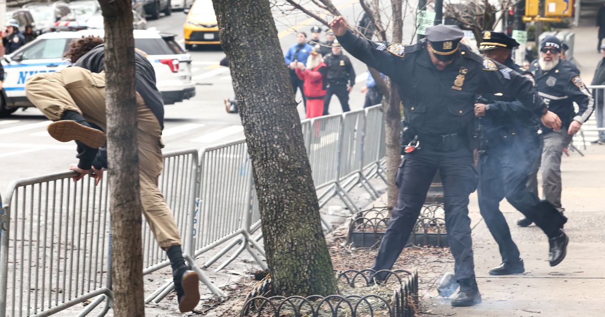 A left-wing activist flees the scene after throwing a homemade explosive device at anti-"Islamification" protesters in New York on March 7, 2026.
