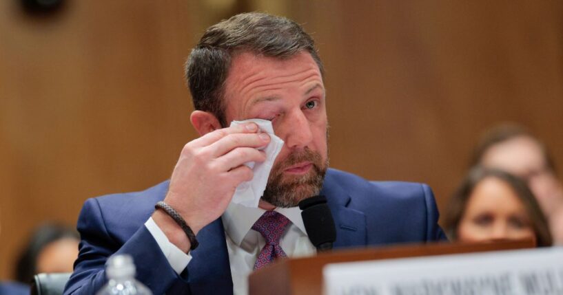 Republican Sen. Markwayne Mullin becomes emotional as he testifies at a confirmation hearing in Washington, DC, on March 18, 2026.