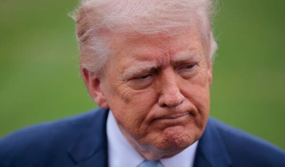 President Donald Trump stops to speak with reporters outside the White House on March 20, 2026, in Washington, DC.