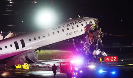 An Air Canada Express plane sits on the tarmac after a crash at LaGuardia Airport on March 23, 2026.