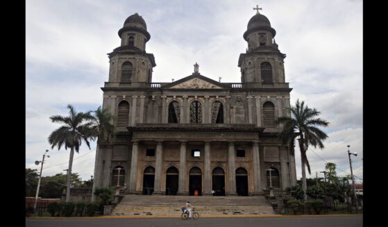A man rides his bike in front of an old cathedral in Managua, Nicaragua on Oct. 19, 2009.