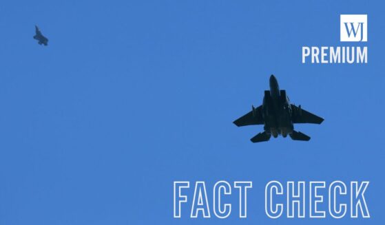 A US Air Force F-15 Strike Eagle fighter aircraft flies alongside a fifth generation F-35A Lighting II stealth aircraft in Lakenheath, England, on April 17, 2025.