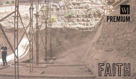 A man working for the Israeli Antiquities Authority walks through a newly uncovered dam in the city of David national Park in Jerusalem on Aug. 26, 2025.