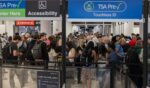 Travelers wait in a TSA pre-check security line at Miami International Airport in Miami, Florida. Travelers across the country are enduring long airport security lines as a partial federal government shutdown affects Transportation Security Administration officers, who recently received $0 paychecks.