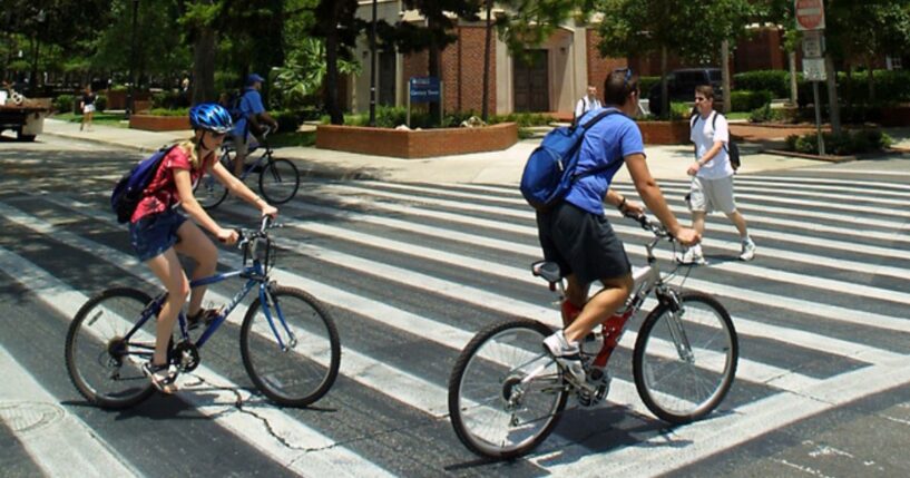 University of Florida students make their way through a crosswalk near the campus landmark Century Tower in Gainesville, Florida.