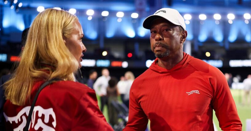 Tiger Woods of Jupiter Links Golf Club talks with his girlfriend, Vanessa Trump, after a match against Boston Common Golf March 17 in Palm Beach Gardens, Florida.
