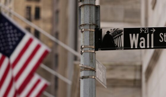 A Wall Street sign is seen outside of the New York Stock Exchange in New York, Monday.