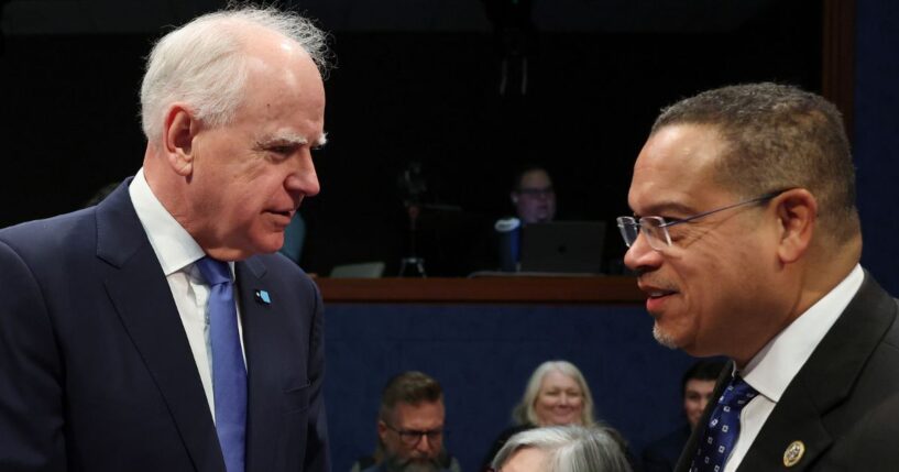 Minnesota Gov. Tim Walz speaks to Minnesota Attorney General Keith Ellison, right, as they arrive to testify during a House Oversight and Government Reform Committee hearing Wednesday in Washington, D.C. The committee held the hearing to examine the alleged misuse of federal funds intended for Minnesota social services and Medicaid programs.