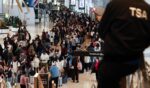 Huge lines of passengers clog New York's LaGuardia airport on Sunday,