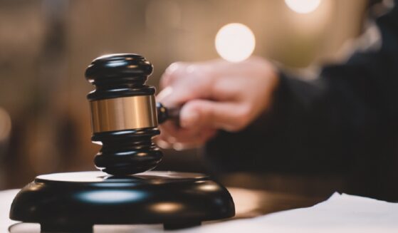 A judge's hand holding a gavel.