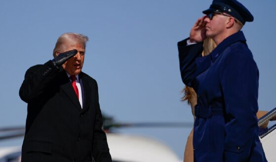 President Donald Trump salutes his military guard while boarding Air Force One in a Feb. 13 file photo.