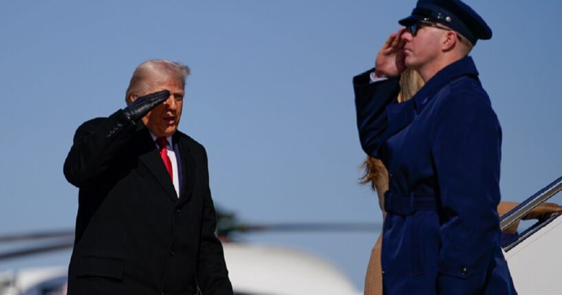 President Donald Trump salutes his military guard while boarding Air Force One in a Feb. 13 file photo.