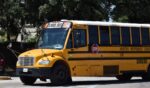 A Houston school bus charter near a water fountain in Houston, Texas.
