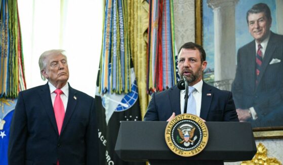 President Donald Trump looks on as newly sworn in Secretary of Homeland Security Markwayne Mullin speaks in the Oval Office of the White House in Washington, D.C., on March 24, 2026.