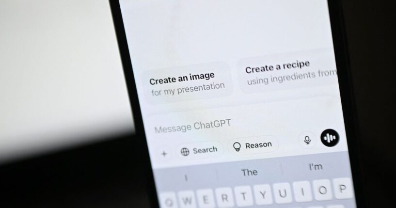 An illustration photograph taken on Feb. 20, 2025, shows the ChatGPT app and website are displayed on a phone and laptop screens, in a residential property in Guildford, south of London.