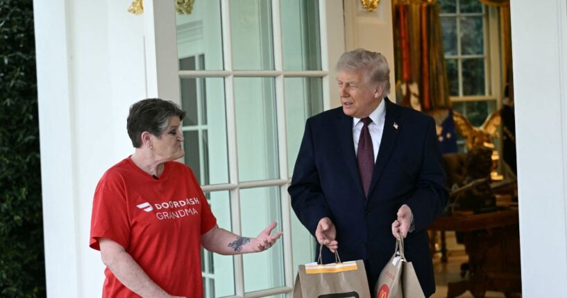 President Donald Trump speaks with a DoorDash delivery worker after she delivered McDonald's at the Oval Office at the White House in Washington, D.C., on April 13, 2026.