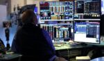 A trader works on the floor of the New York Stock Exchange during the opening bell in New York, on April 13, 2026.