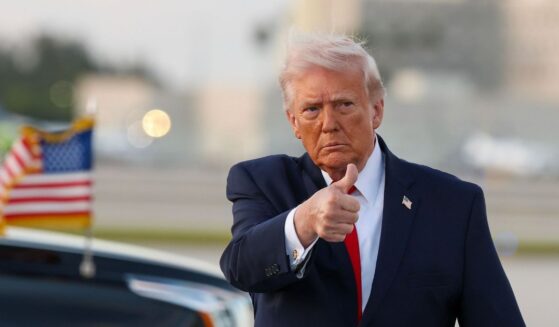 President Donald Trump waves to the media after walking off of Air Force One at Miami International Airport on April 11, 2026, in Miami, Florida.